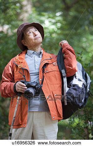 Stock Photograph - Senior man with camera. Fotosearch