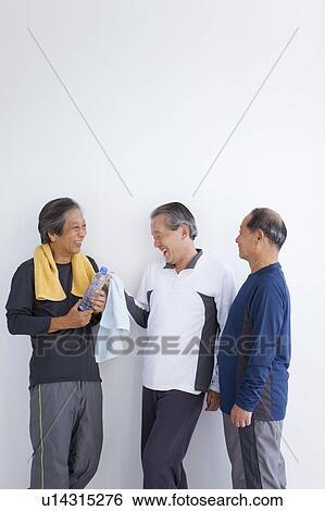 Senior men standing and talking View Large Photo Image Stock Photograph - Senior men standing and talking. Fotosearch