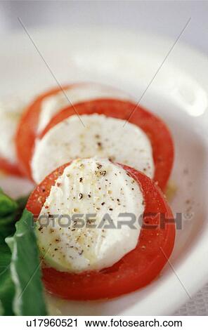 Slices of tomatoes and cheese View Large Photo Image Stock Image - Slices of tomatoes and cheese. Fotosearch