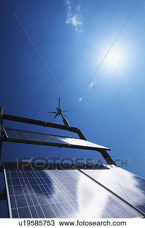 Stock Image - Sun Shining Over Solar Panels. Fotosearch