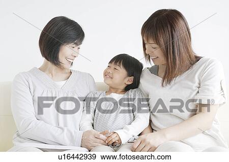 Three generations of women sitting on sofa View Large Photo Image Stock Photo - Three generations of women sitting on sofa. Fotosearch