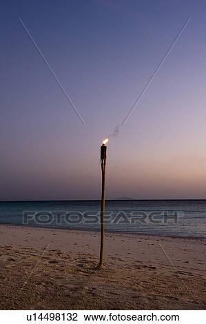 Stock Image - Torch on Beach. Fotosearch