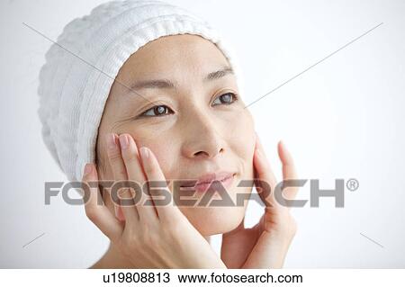Woman massaging her face View Large Photo Image Stock Image - Woman massaging her face. Fotosearch