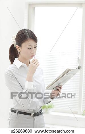 Woman Reading Newspaper Whilst Brushing Teeth View Large Photo Image Stock Image - Woman Reading Newspaper Whilst Brushing Teeth. Fotosearch