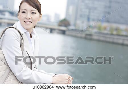 Picture - Young businesswoman looking away. Fotosearch