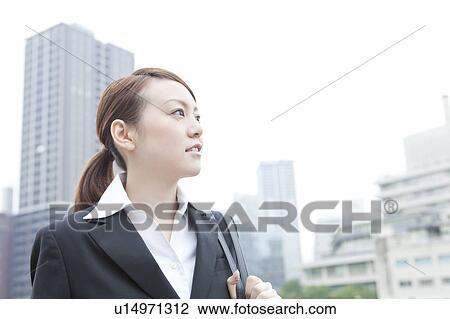 Young businesswoman looking away View Large Photo Image Stock Image - Young businesswoman looking away. Fotosearch