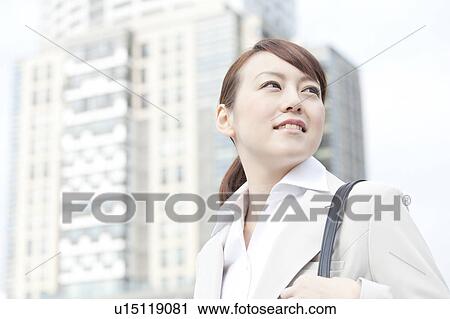 Young businesswoman looking away View Large Photo Image Stock Image - Young businesswoman looking away. Fotosearch