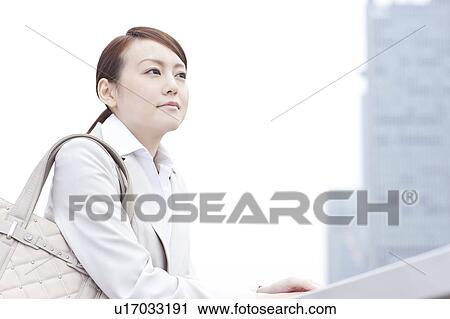 Young businesswoman looking away View Large Photo Image Stock Image - Young businesswoman looking away. Fotosearch