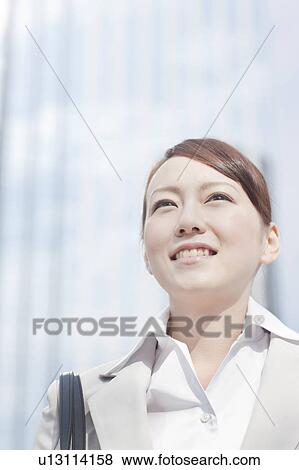 Stock Photo - Young businesswoman looking away. Fotosearch