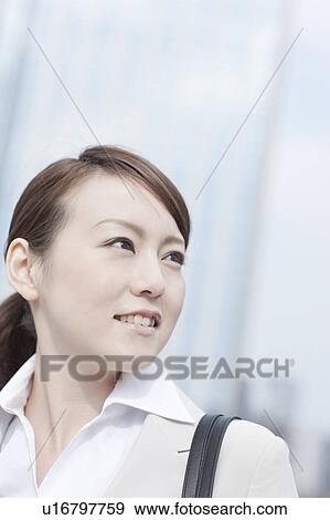 Young businesswoman looking away View Large Photo Image Stock Photo - Young businesswoman looking away. Fotosearch
