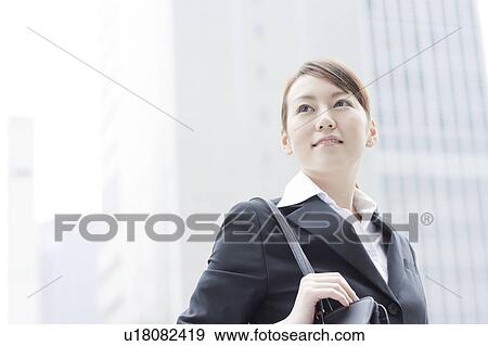 Young businesswoman looking away View Large Photo Image Stock Photo - Young businesswoman looking away. Fotosearch