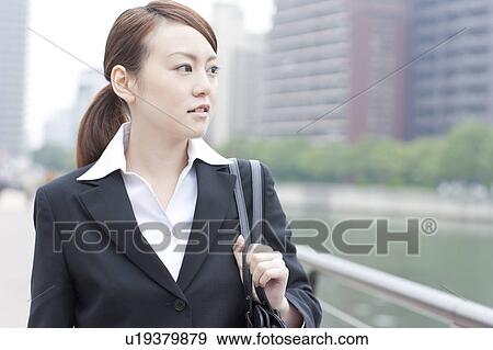 Stock Photo - Young businesswoman looking away. Fotosearch