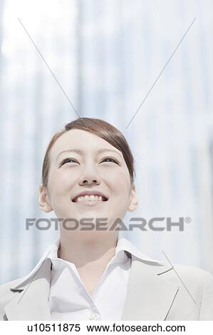 Stock Photography - Young businesswoman looking away. Fotosearch