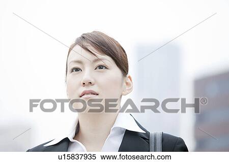 Young businesswoman looking away View Large Photo Image Stock Photography - Young businesswoman looking away. Fotosearch