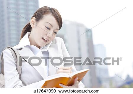 Young businesswoman on cell phone View Large Photo Image Stock Image - Young businesswoman on cell phone. Fotosearch