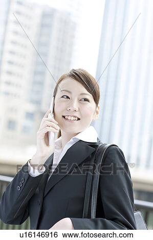 Young businesswoman on cell phone View Large Photo Image Stock Photograph - Young businesswoman on cell phone. Fotosearch