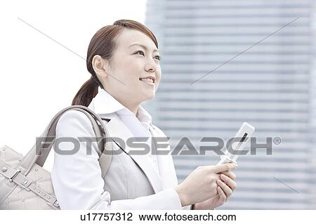 Young businesswoman text messaging View Large Photo Image Stock Image - Young businesswoman text messaging. Fotosearch