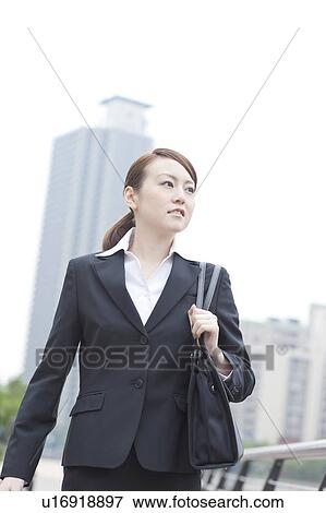 Young businesswoman walking View Large Photo Image Stock Photo - Young businesswoman walking. Fotosearch
