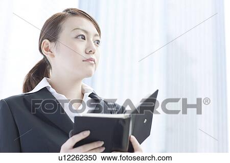 Young businesswoman with a diary View Large Photo Image Stock Image - Young businesswoman with a diary. Fotosearch