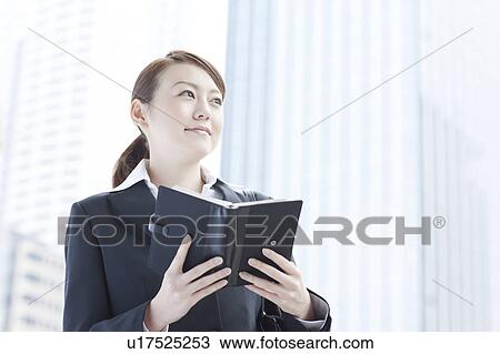 Young businesswoman with a diary View Large Photo Image Stock Image - Young businesswoman with a diary. Fotosearch