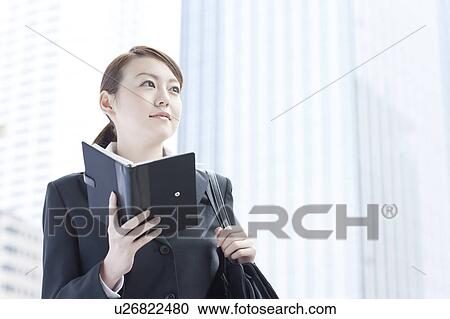 Young businesswoman with a diary View Large Photo Image Stock Image - Young businesswoman with a diary. Fotosearch