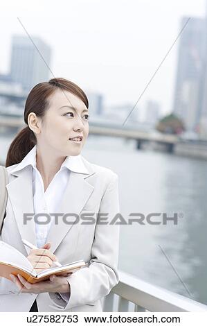 Young businesswoman with a diary View Large Photo Image Stock Image - Young businesswoman with a diary. Fotosearch