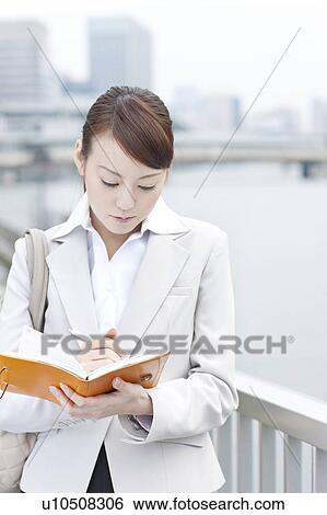 Stock Photograph - Young businesswoman with a diary. Fotosearch