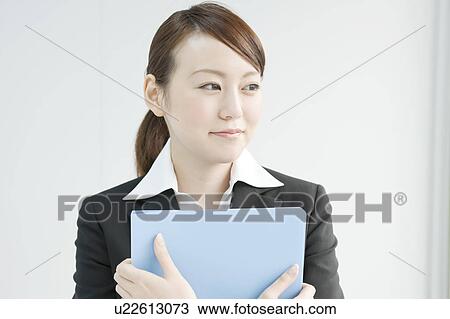Stock Image - Young Businesswoman with File. Fotosearch
