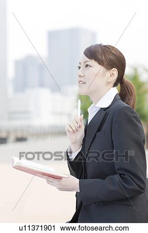 Stock Image - Young Businesswoman with Personal Organizer Outdoors. Fotosearch