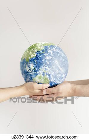 Picture - Young couple holding globe. Fotosearch