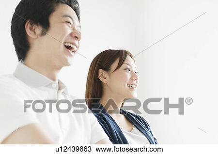 Stock Image - Young couple laughing. Fotosearch