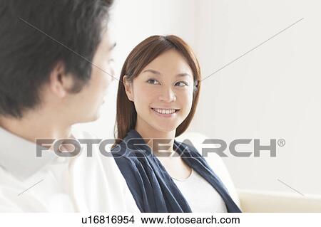 Young couple looking at each other View Large Photo Image Picture - Young couple looking at each other. Fotosearch