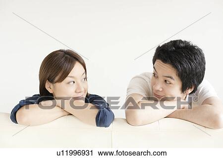 Stock Image - Young couple looking at each other. Fotosearch