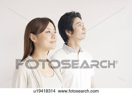 Picture - Young couple looking away. Fotosearch