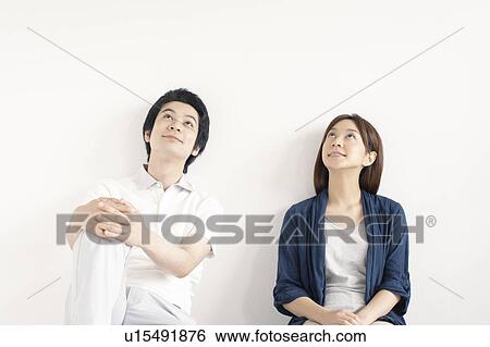 Stock Photograph - Young couple looking up. Fotosearch
