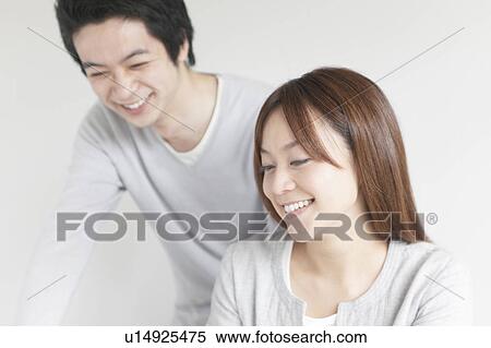 Young couple smiling View Large Photo Image Stock Photography - Young couple smiling. Fotosearch