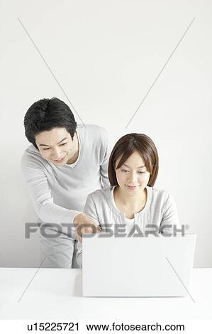 Young couple using laptop View Large Photo Image Stock Image - Young couple using laptop. Fotosearch