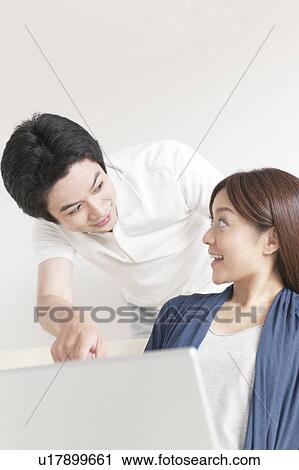 Young couple using laptop View Large Photo Image Stock Image - Young couple using laptop. Fotosearch