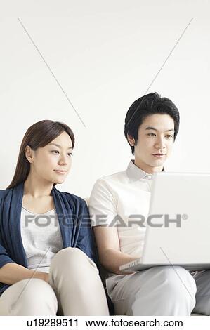 Young couple using laptop View Large Photo Image Stock Image - Young couple using laptop. Fotosearch