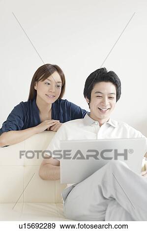 Young couple using laptop View Large Photo Image Stock Photo - Young couple using laptop. Fotosearch