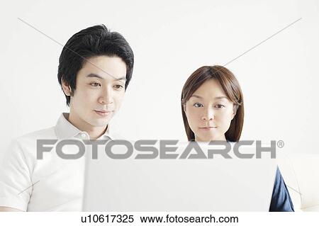 Young couple using laptop View Large Photo Image Stock Photography - Young couple using laptop. Fotosearch