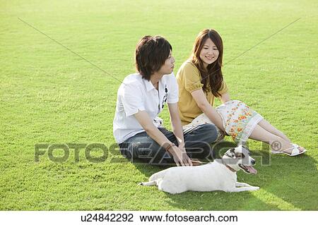Young couple with a dog View Large Photo Image Stock Image - Young couple with a dog. Fotosearch