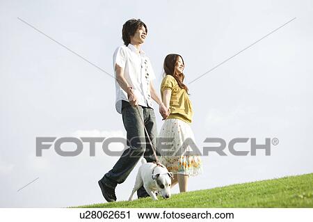 Young couple with a dog View Large Photo Image Stock Image - Young couple with a dog. Fotosearch