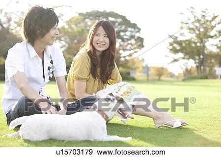 Young couple with a dog View Large Photo Image Stock Photo - Young couple with a dog. Fotosearch