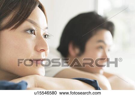 Stock Image - Young couple with arms crossed. Fotosearch