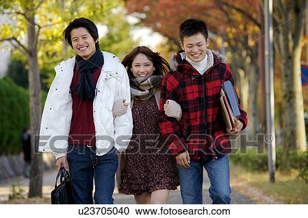 Stock Image - Young friends walking. Fotosearch