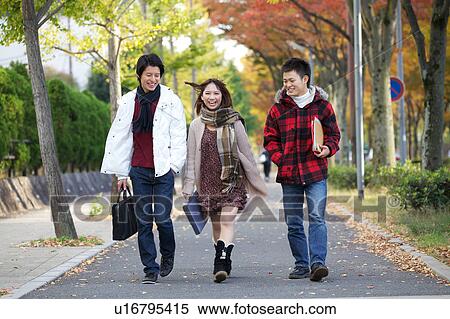 Young friends walking View Large Photo Image Stock Photography - Young friends walking. Fotosearch