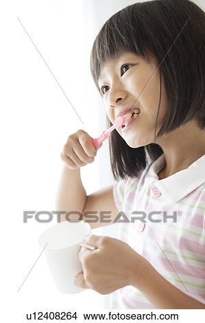 Picture - Young Girl Brushing Teeth. Fotosearch