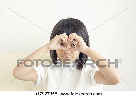 Stock Photo - Young Girl Forming Binoculars With Fingers. Fotosearch