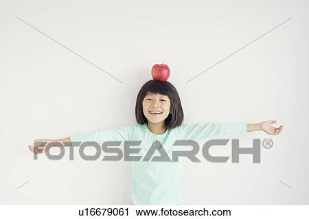Young Girl Holding Apple on Her Head View Large Photo Image Stock Image - Young Girl Holding Apple on Her Head. Fotosearch